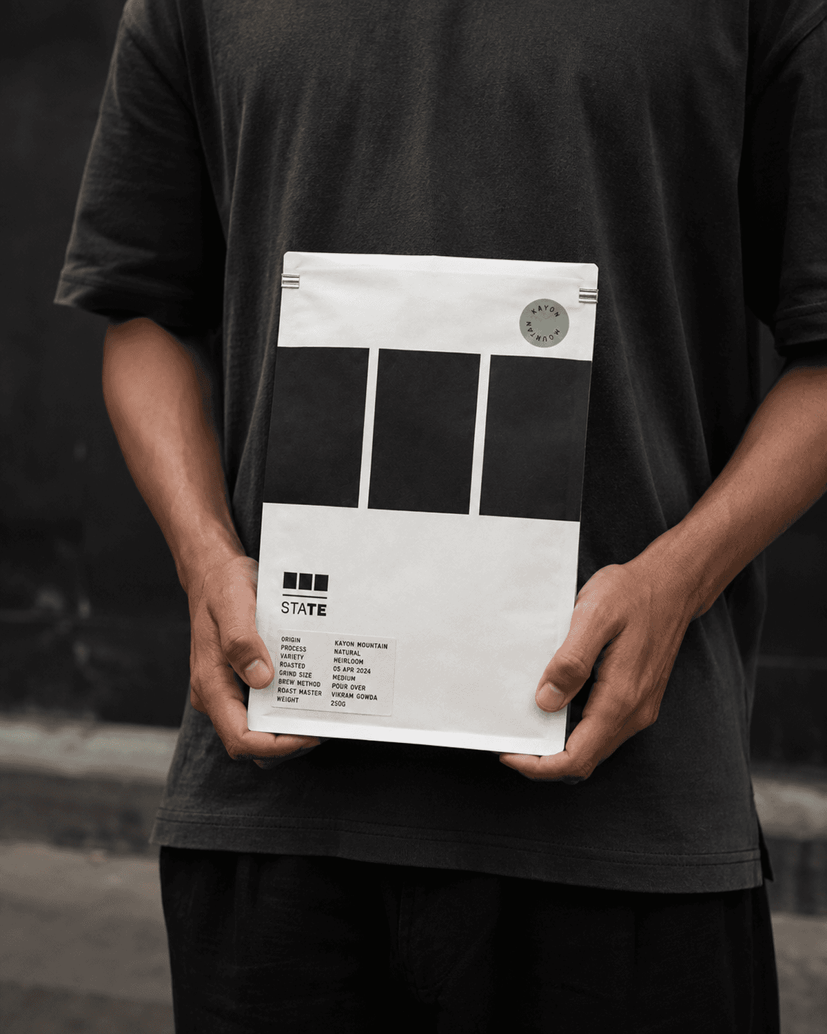 A State coffee pack suspended against a dark ground.