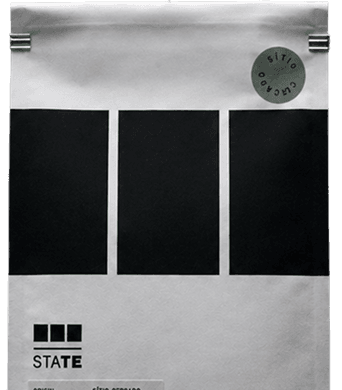 A State coffee pack standing upright, its three black blocks and spec label facing forward.
